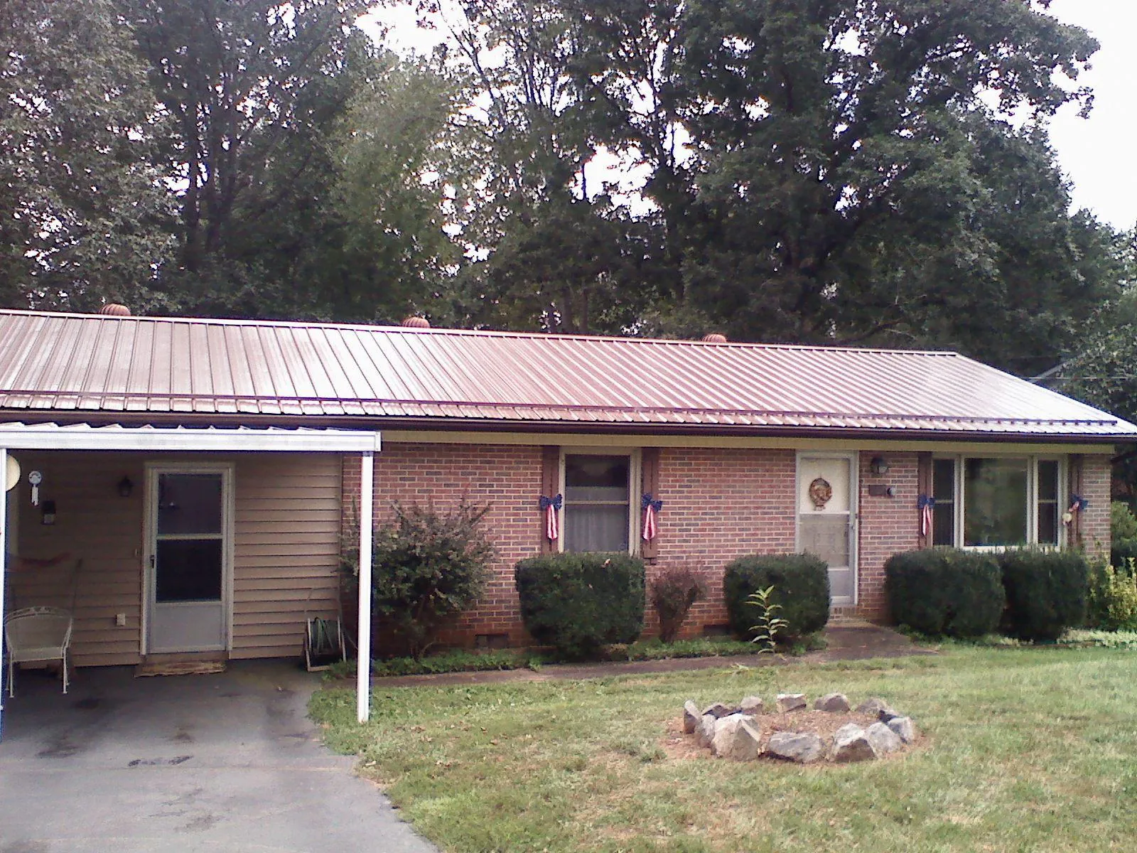 Bronze metal roof and carport on a brick ranch home — Roof Repair work by our crew in Macclesfield